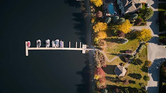 A row of houses are lined up along a body of water.