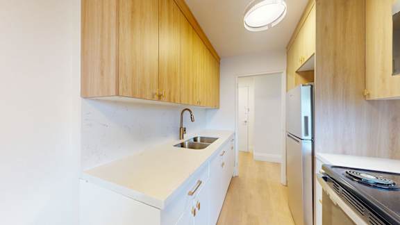 A kitchen with wooden cabinets and stainless steel appliances.