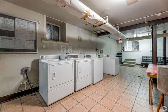 A laundry room with washers and dryers.