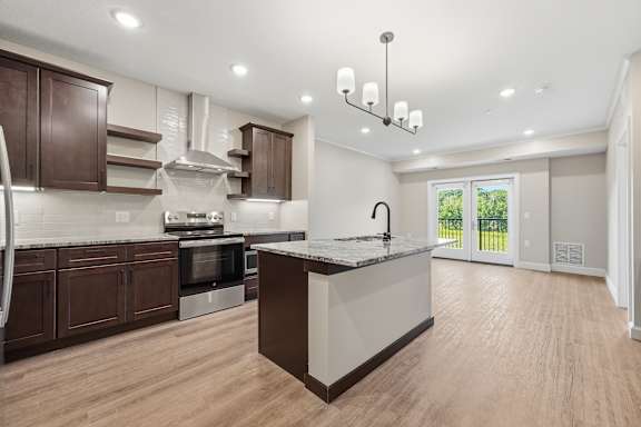 A kitchen with wooden floors and a large island.