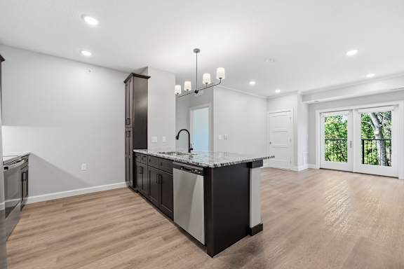 A modern kitchen with a large island and stainless steel appliances.