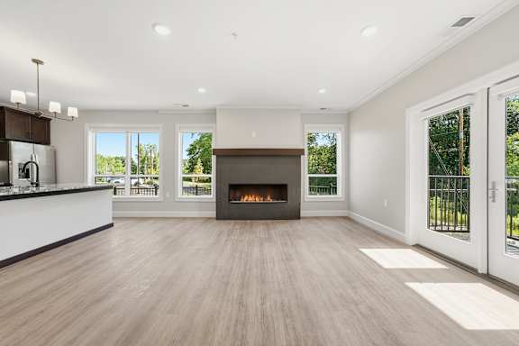 A modern living room with a fireplace and sliding glass doors.