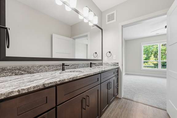 A kitchen with a granite countertop and wooden cabinets.