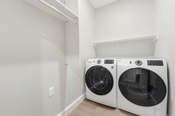Two front load washing machines in a laundry room.