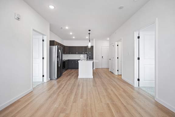 A kitchen with a white island in the middle of the room.