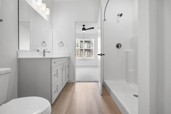 A white bathroom with a toilet, sink, and bathtub.