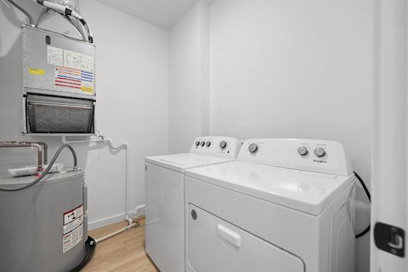 A washing machine and dryer in a small laundry room.