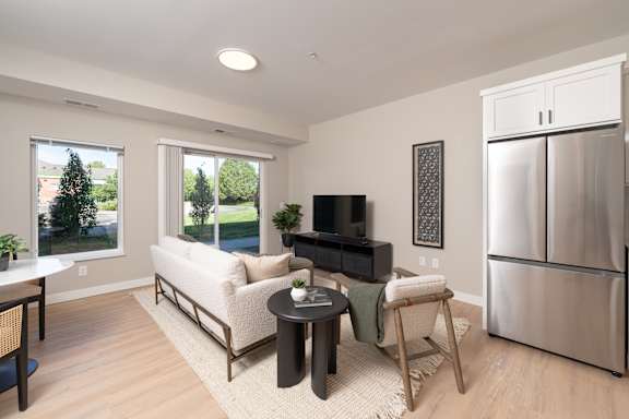 A modern living room with a white sofa and a black television.