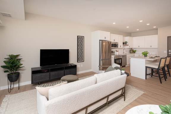 A modern living room with a white couch and a television.