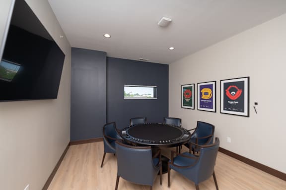 A shared game table with seating and a wall-mounted TV