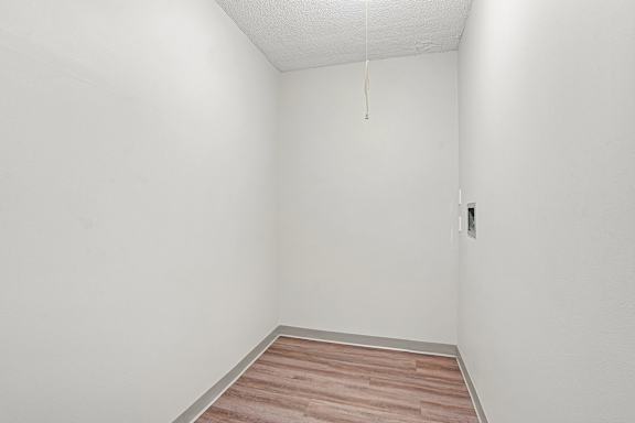 Irvine Park Towers apartment storage or utility space with wood-look flooring