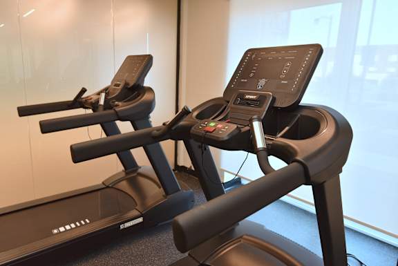 Two treadmills are placed next to each other in a room at Roxy Apartments, Hamilton, ON