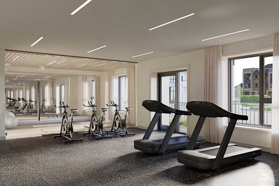 A gym with treadmills, exercise bikes and a view of the outside at Roxy Apartments, Ontario