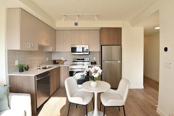 A kitchen with a table and chairs at Roxy Apartments, Hamilton, ON, L8H 0B7