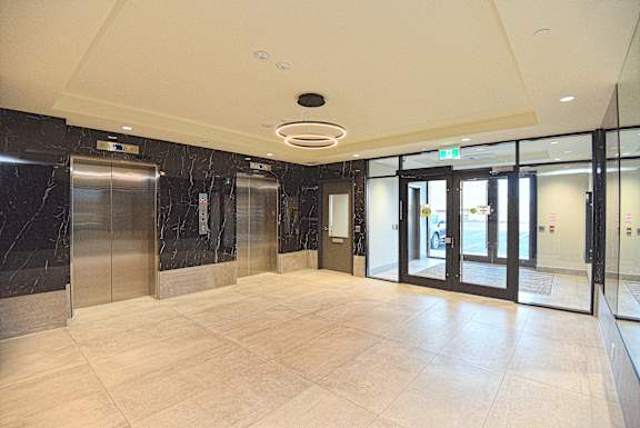 A spacious lobby with marble floors and a ceiling light at Roxy Apartments, Hamilton, ON, L8H 0B7