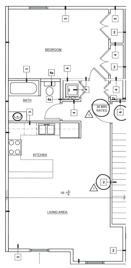 A floor plan of a small apartment with a bedroom, living area, and kitchen.