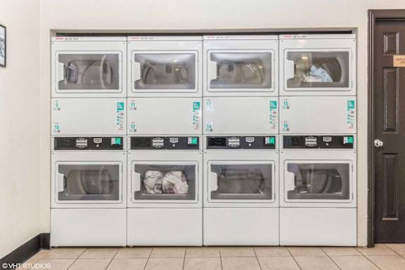 A row of white ovens with blue labels on them.