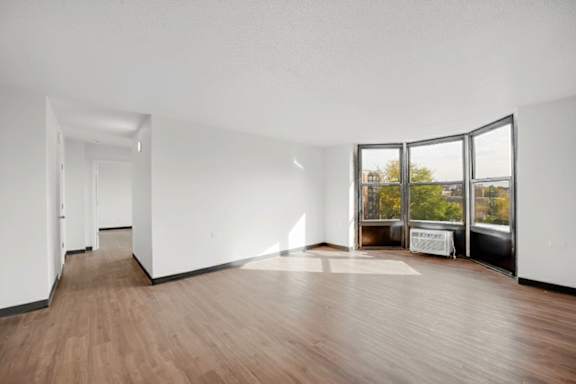A room with wooden floors and white walls.