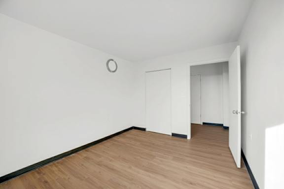 A room with a wooden floor and white walls.