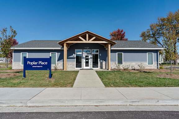 The front of a building with a sign that says "Poplar Place Assisted Living".