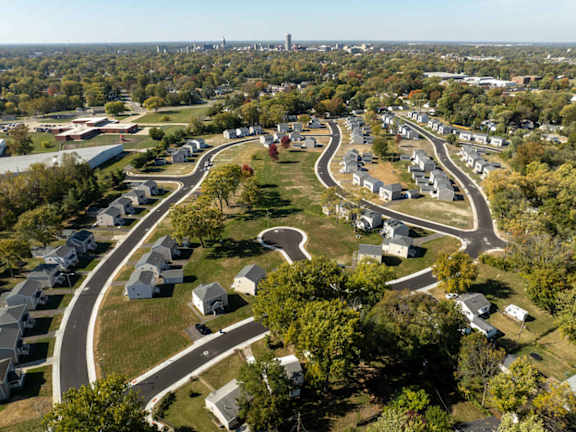 A bird's eye view of a residential area with curved roads and houses.