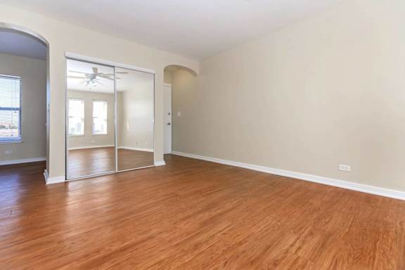 A room with wooden floors and white walls.
