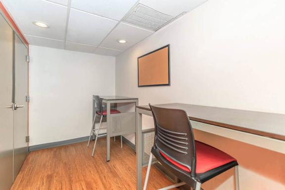 A room with a desk and a chair.