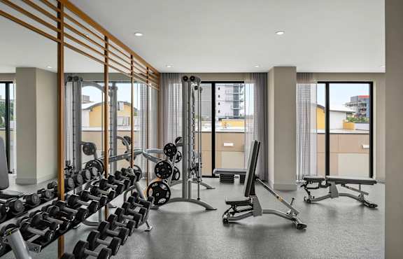 A gym with a row of dumbbells and weight machines. at Palma, Florida