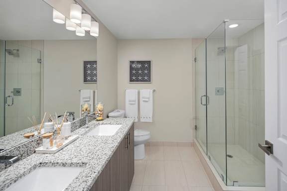 A bathroom with a sink, toilet, and shower. at Palma, Doral, FL