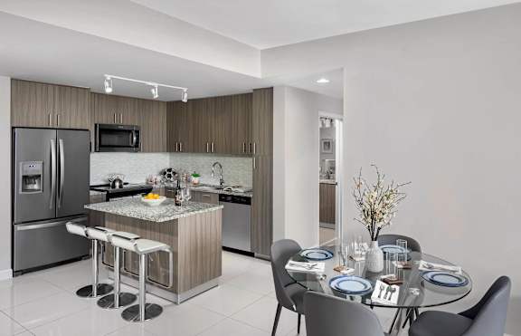 A modern kitchen with a dining table at Palma, Doral, FL, 33166