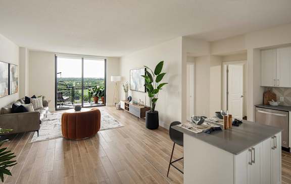 A modern living room with a large window and a kitchen area. at Palma, Florida