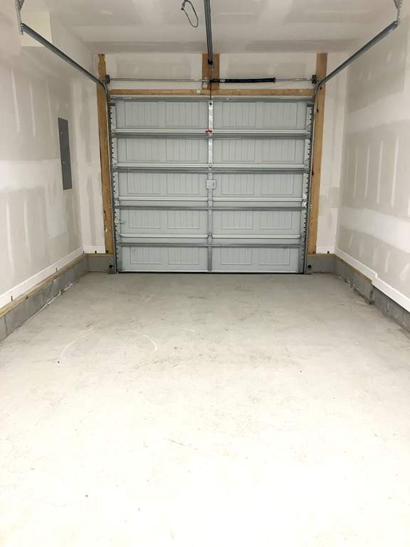 A white garage door is closed.