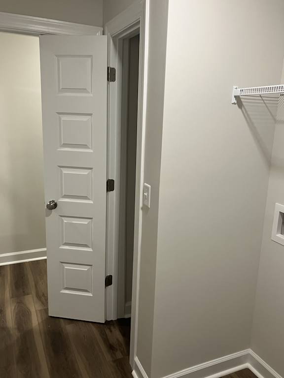 A white door is open to a hallway.