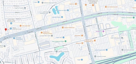 A map with a red pin on the corner of a street.