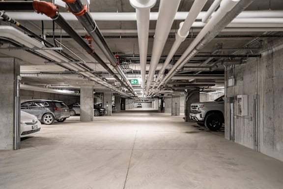 A parking garage with concrete floors and white walls.