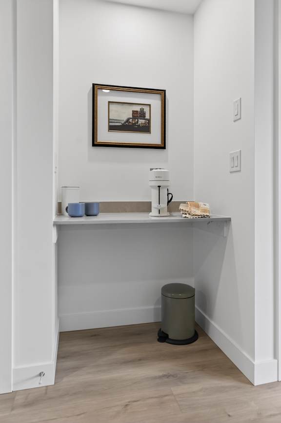 A bathroom with a white sink and a picture frame on the wall.