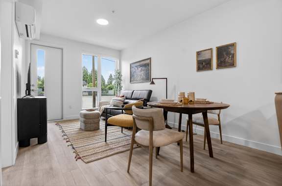 A modern living room with a brown wooden table and chairs.