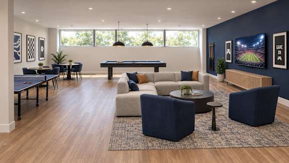 A modern living room with a pool table and comfortable seating.