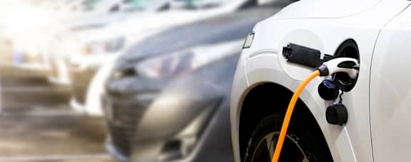 An electric car is plugged into a charging station.