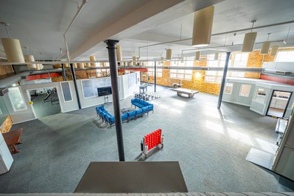 A view of a cafeteria from the top of the stairs.