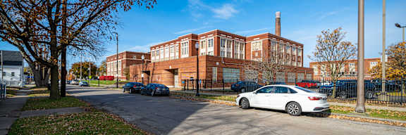 A white car is parked on the side of a street.