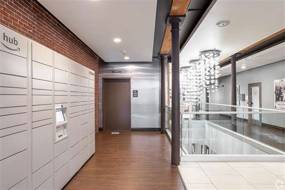 A hallway with a brick wall and a sign that says "hub" on it.