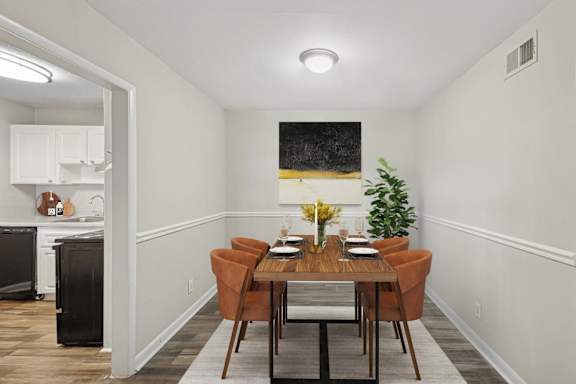 A dining room with a wooden table and chairs.