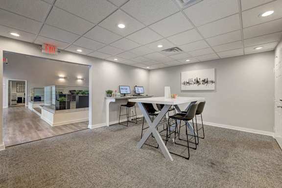 A conference room with a table and chairs.
