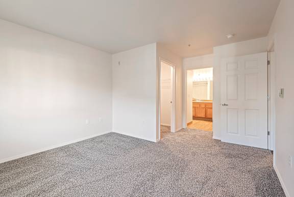 A room with a carpeted floor and white walls.