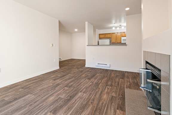 A room with a wood floor and a fireplace.
