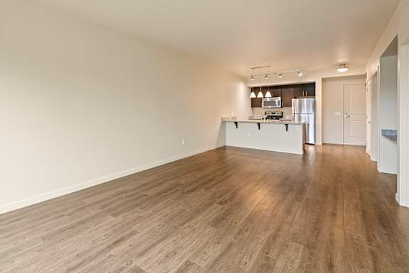A kitchen area with a refrigerator, oven, and sink.