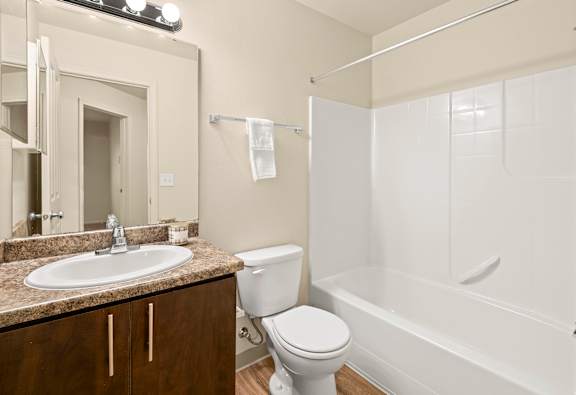 A white toilet sits next to a sink in a bathroom.