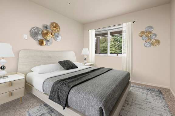 A bedroom with a large bed and two wall decorations.