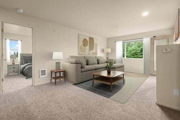 A living room with a couch, a coffee table, and a lamp.